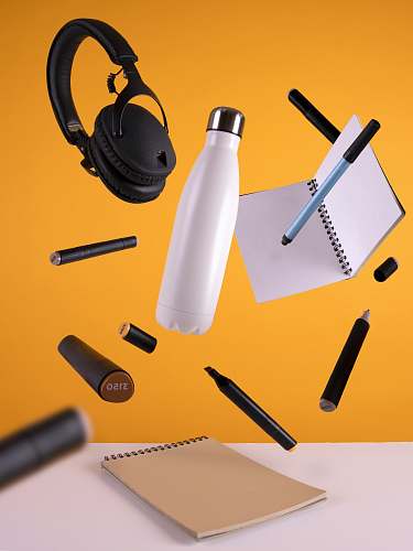 kobu agency black cordless headphones beside sport bottle and notebook faro